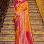 Orange Banarasi Silk Saree Featuring Intricate Floral Weaving & Elegant Tassel Pallu